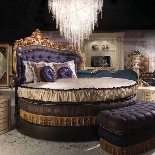 Bespoke Rococo circular bed featuring a hand-carved gilded frame and deep purple button-tufted upholstery, produced by OE-FASHION Interiors.