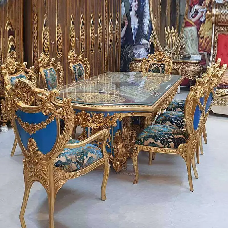Bespoke Royal Blue Gilded Dining Suite featuring a glass-topped table with gold lattice underlay and eight hand-carved