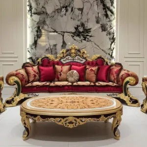 Home 11 A majestic, opulent red Victorian luxury sofa with intricate golden hand-carved accents and matching red and gold patterned throw pillows, centered in a lavish room with a marble-patterned wall.