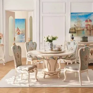 Eye-level shot of the round pedestal dining table showing the sturdy base and matching floral chairs in a bright room.